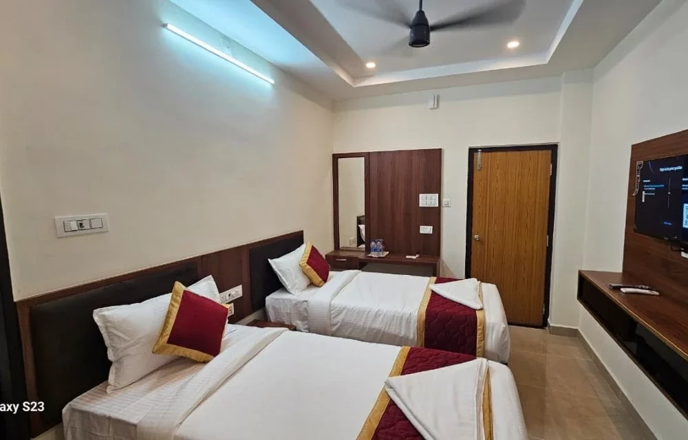 Twin-bed guest room showing the ceiling fan, mirror and entry door